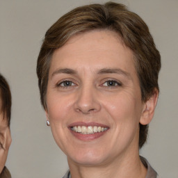 Joyful white adult female with medium  brown hair and brown eyes