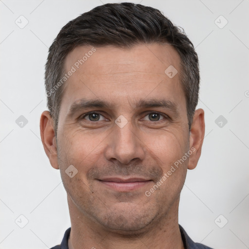 Joyful white adult male with short  brown hair and brown eyes