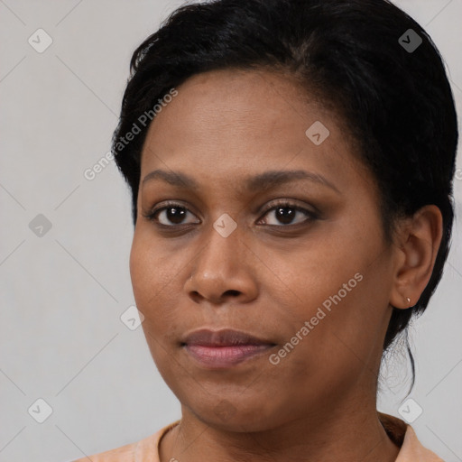 Joyful black young-adult female with short  black hair and brown eyes