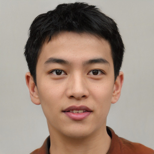 Joyful asian young-adult male with short  black hair and brown eyes