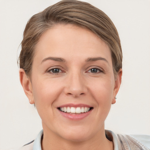 Joyful white young-adult female with short  brown hair and grey eyes