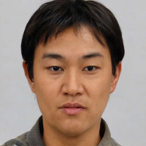 Neutral asian young-adult male with short  brown hair and brown eyes