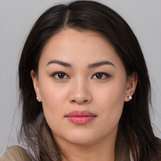 Joyful asian young-adult female with long  brown hair and brown eyes