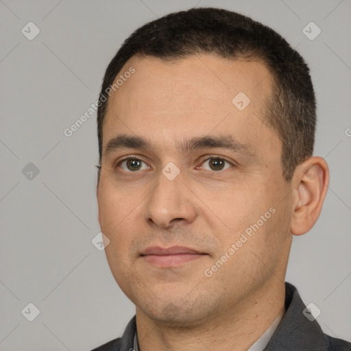 Joyful white young-adult male with short  black hair and brown eyes