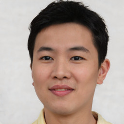 Joyful asian young-adult male with short  black hair and brown eyes