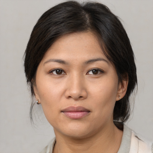 Joyful white young-adult female with medium  brown hair and brown eyes