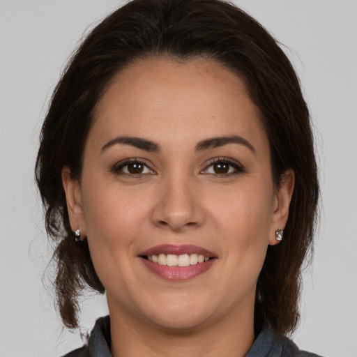 Joyful white young-adult female with medium  brown hair and brown eyes