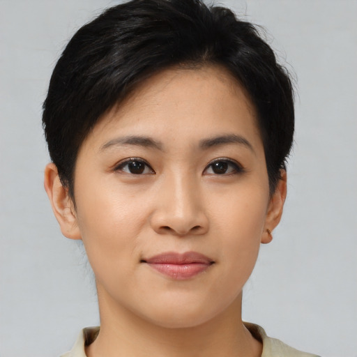 Joyful asian young-adult female with short  brown hair and brown eyes