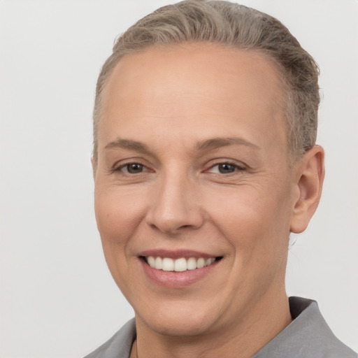 Joyful white adult female with short  brown hair and brown eyes