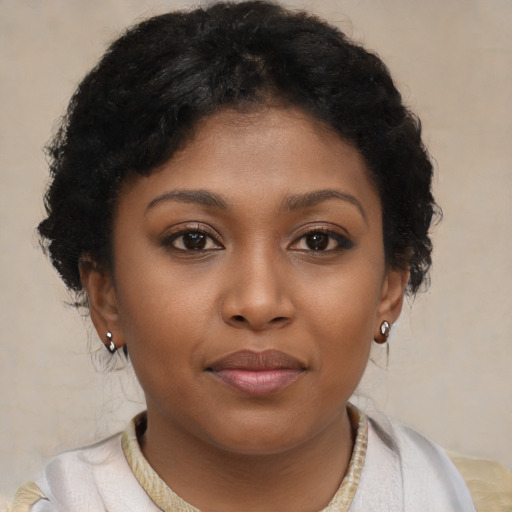 Joyful black young-adult female with short  brown hair and brown eyes