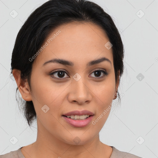 Joyful latino young-adult female with medium  brown hair and brown eyes