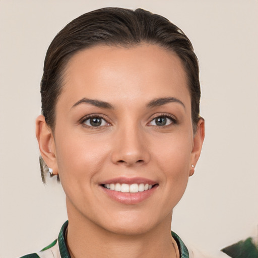 Joyful white young-adult female with short  brown hair and brown eyes