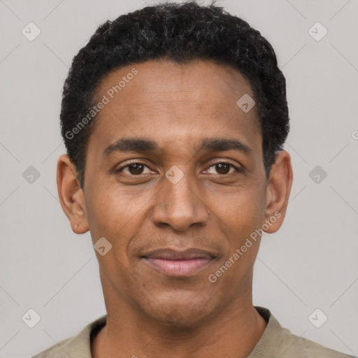 Joyful black adult male with short  black hair and brown eyes