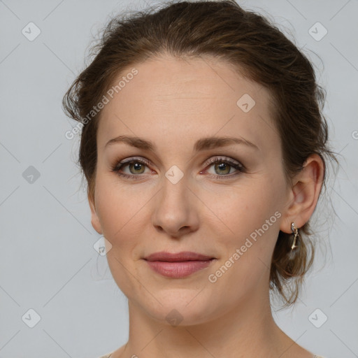 Joyful white young-adult female with medium  brown hair and green eyes