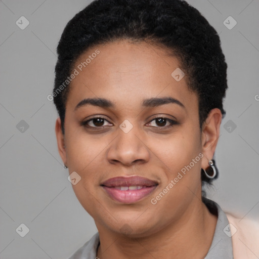 Joyful black young-adult female with short  black hair and brown eyes