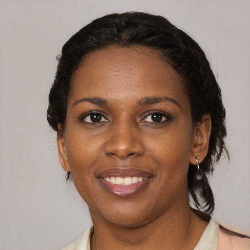 Joyful black young-adult female with medium  black hair and brown eyes