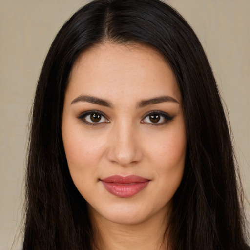 Joyful latino young-adult female with long  brown hair and brown eyes