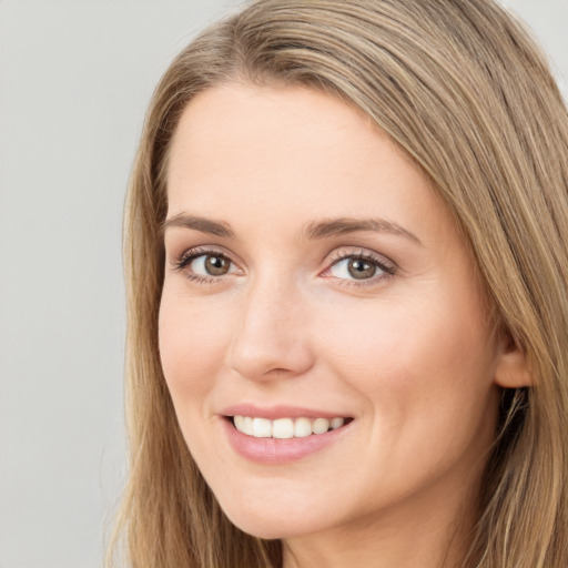 Joyful white young-adult female with long  brown hair and green eyes