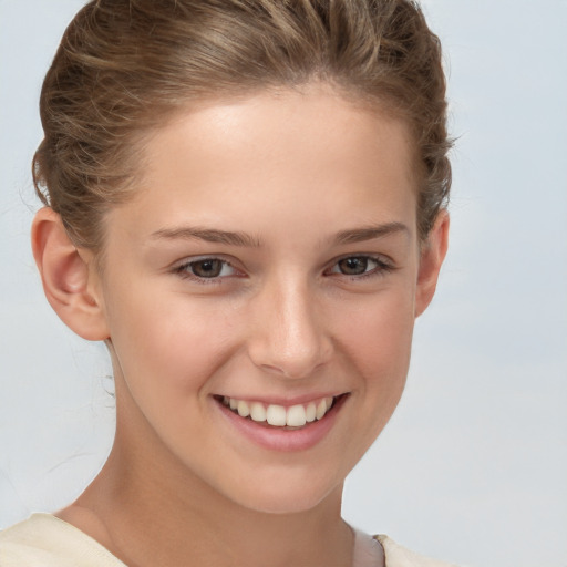 Joyful white child female with short  brown hair and brown eyes