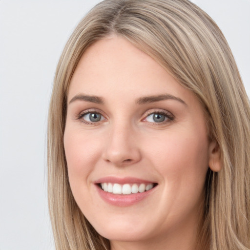 Joyful white young-adult female with long  brown hair and green eyes