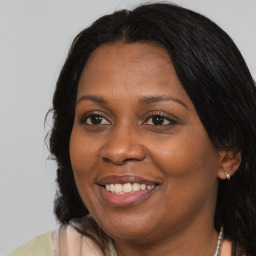 Joyful black adult female with medium  brown hair and brown eyes