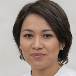 Joyful white adult female with medium  brown hair and brown eyes