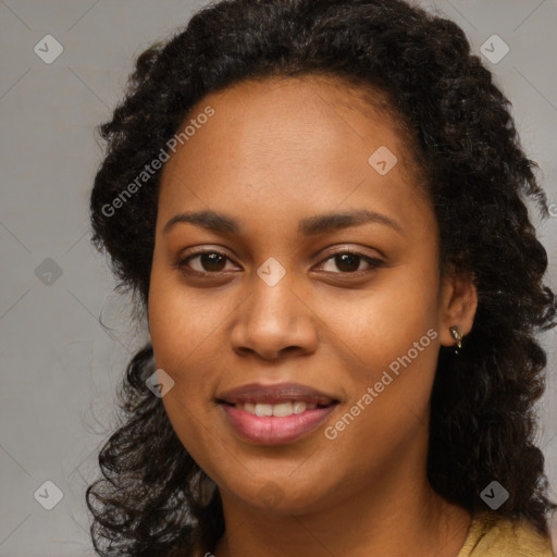 Joyful black young-adult female with long  brown hair and brown eyes