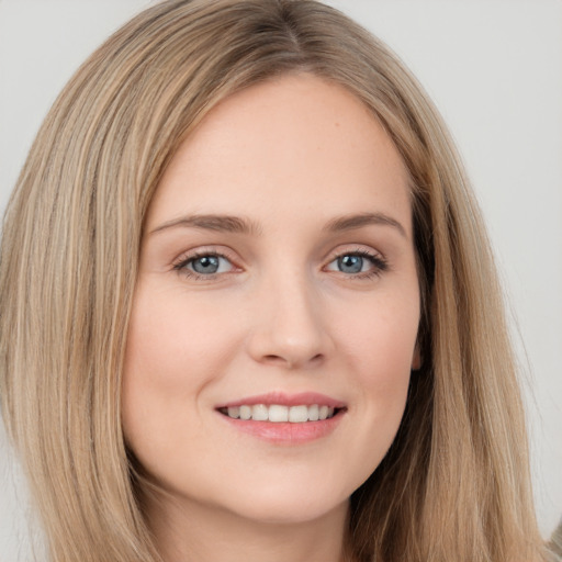 Joyful white young-adult female with long  brown hair and grey eyes