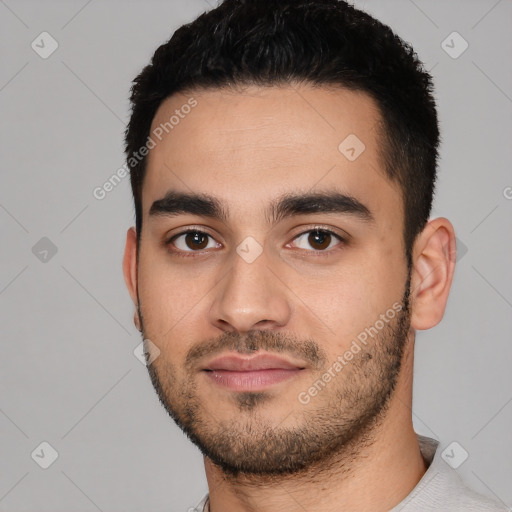 Joyful white young-adult male with short  black hair and brown eyes