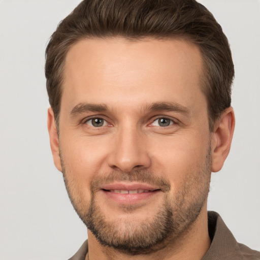 Joyful white young-adult male with short  brown hair and brown eyes