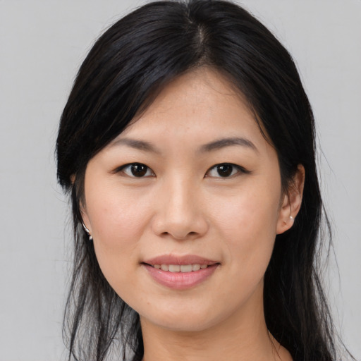 Joyful asian young-adult female with long  brown hair and brown eyes