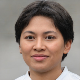 Joyful asian young-adult female with short  brown hair and brown eyes