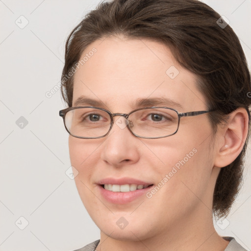 Joyful white young-adult female with medium  brown hair and grey eyes