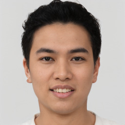 Joyful asian young-adult male with short  black hair and brown eyes