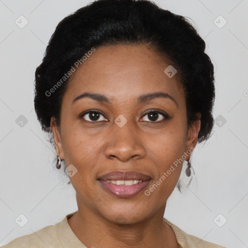 Joyful black adult female with short  black hair and brown eyes