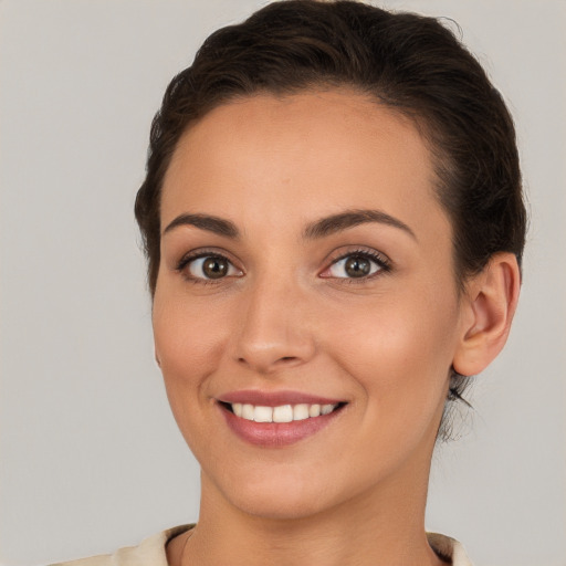 Joyful white young-adult female with medium  brown hair and brown eyes