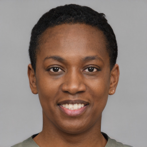 Joyful black young-adult female with short  black hair and brown eyes