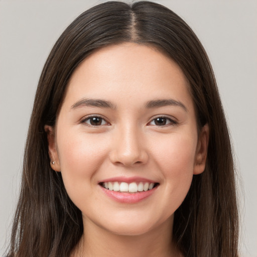 Joyful white young-adult female with long  brown hair and brown eyes