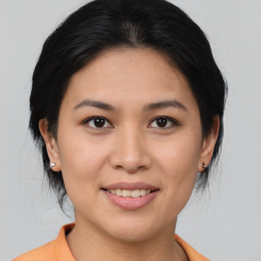 Joyful asian young-adult female with medium  brown hair and brown eyes