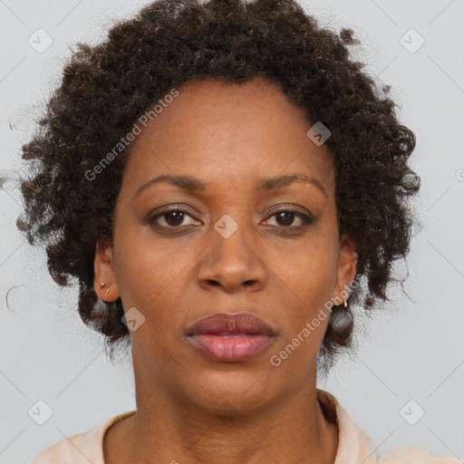 Joyful black adult female with medium  brown hair and brown eyes