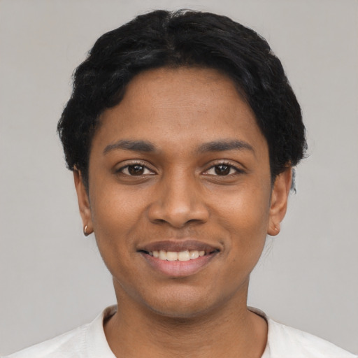 Joyful latino young-adult female with short  black hair and brown eyes