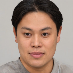 Joyful asian young-adult male with short  brown hair and brown eyes