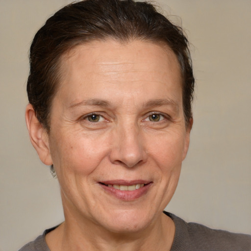 Joyful white middle-aged female with short  brown hair and brown eyes