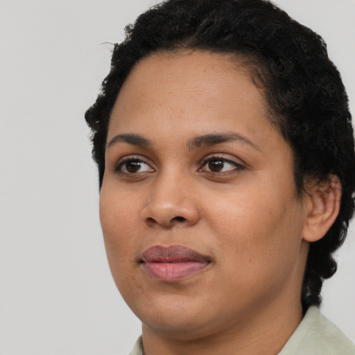 Joyful latino young-adult female with short  black hair and brown eyes
