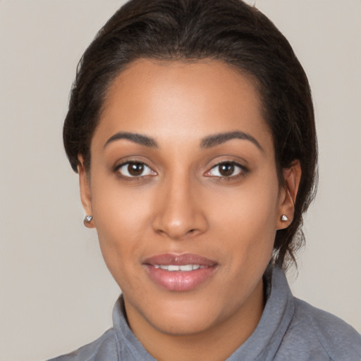 Joyful latino young-adult female with short  brown hair and brown eyes