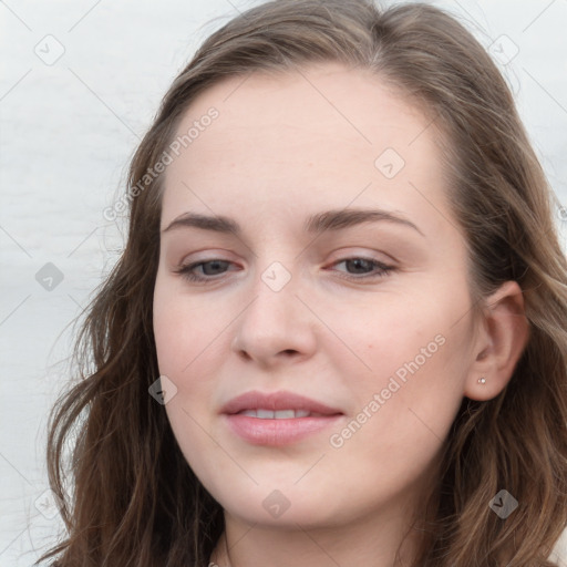 Joyful white young-adult female with long  brown hair and blue eyes