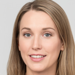 Joyful white young-adult female with long  brown hair and grey eyes