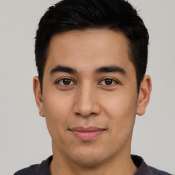 Joyful latino young-adult male with short  brown hair and brown eyes