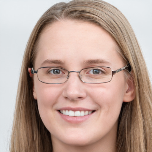 Joyful white young-adult female with long  brown hair and blue eyes