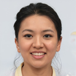 Joyful asian young-adult female with short  brown hair and brown eyes